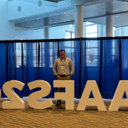 Nick Ewing standing behind a sign that says "AAFS2"