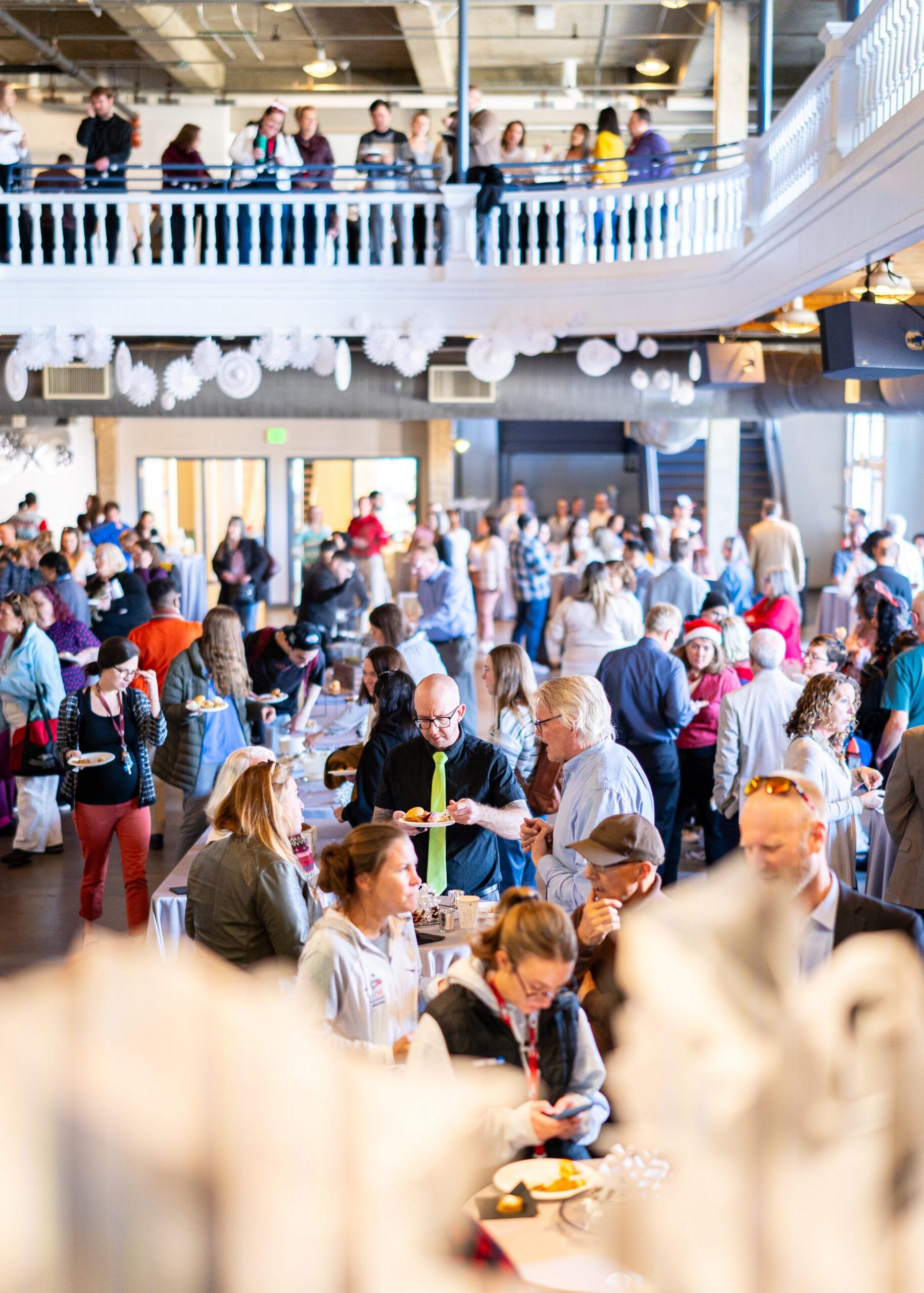 A large group of MSU Denver Faculty and Staff celebrate at the Holiday Fest in the Tivoli Turnhalle